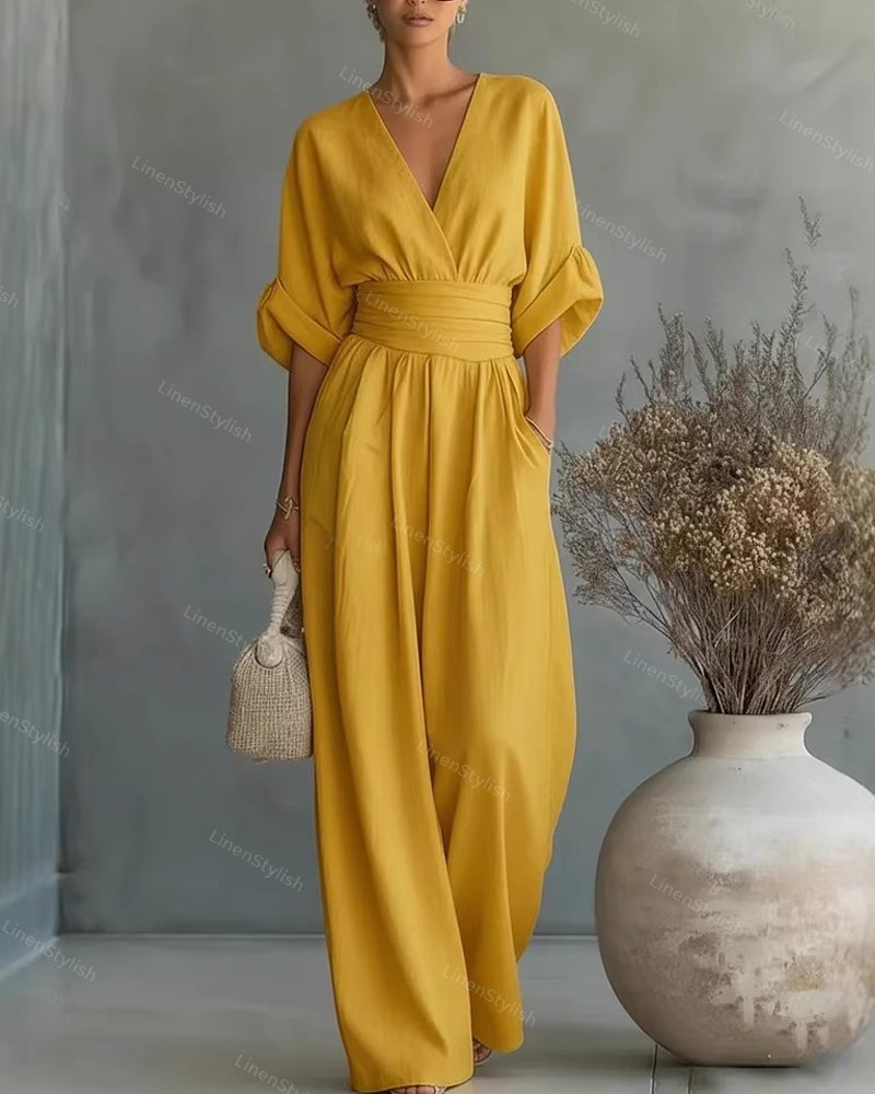Combinaison femme avec décolleté plongeant en V, ceinture et jambes larges
