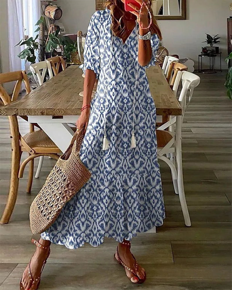 Long bohemian dress with V-neck and flowing drape